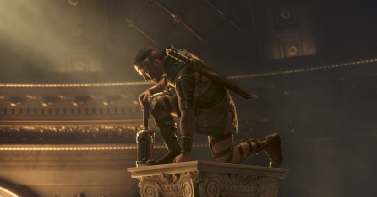 Hercules (Brett Goldstein) kneels with hammer in hand on a composite column in a shot from Thor: Love and Thunder